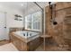 Bathroom with soaking tub, walk-in shower, and tile flooring at 124 Streamwood Rd, Troutman, NC 28166