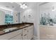 Bathroom with granite countertop, double sinks, and view of bedroom at 124 Streamwood Rd, Troutman, NC 28166