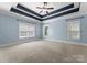 Spacious bedroom with light blue walls, ceiling fan, and neutral carpet at 124 Streamwood Rd, Troutman, NC 28166