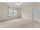 Bedroom with window, ceiling fan, and neutral carpet at 124 Streamwood Rd, Troutman, NC 28166