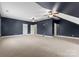 Spacious bonus room with dark blue walls and high ceilings at 124 Streamwood Rd, Troutman, NC 28166