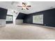 Large bonus room with dark blue walls and two ceiling fans at 124 Streamwood Rd, Troutman, NC 28166