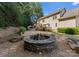 Stone fire pit in backyard surrounded by landscaping at 124 Streamwood Rd, Troutman, NC 28166