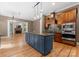 Open kitchen with large island, stainless steel appliances, and hardwood floors at 124 Streamwood Rd, Troutman, NC 28166