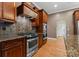Kitchen with stainless steel appliances and slate backsplash at 124 Streamwood Rd, Troutman, NC 28166