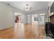 Open living room with hardwood floors and views to kitchen and sunroom at 124 Streamwood Rd, Troutman, NC 28166