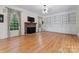 Spacious living room with hardwood floors, fireplace, and built-in shelving at 124 Streamwood Rd, Troutman, NC 28166