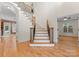 Elegant staircase with wrought iron railings and hardwood floors at 124 Streamwood Rd, Troutman, NC 28166