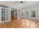 Sunroom with hardwood floors, French doors, and access to deck at 124 Streamwood Rd, Troutman, NC 28166