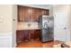 Kitchen with stainless steel refrigerator and ample wood cabinets at 5601 Ballenger Ct, Waxhaw, NC 28173
