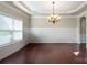 Formal dining room featuring hardwood floors, crown molding, and a chandelier at 5601 Ballenger Ct, Waxhaw, NC 28173