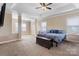 Bright main bedroom with a large bed, plenty of natural light, and a ceiling fan at 5601 Ballenger Ct, Waxhaw, NC 28173