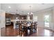 Bright dining area adjacent to kitchen, featuring hardwood floors and backyard access at 5601 Ballenger Ct, Waxhaw, NC 28173