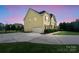 Two story house with a side view of the garage, driveway, and basketball court at 5601 Ballenger Ct, Waxhaw, NC 28173