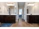 Double vanity bathroom with dark brown cabinets and tile flooring at 5601 Ballenger Ct, Waxhaw, NC 28173