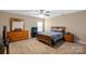 Comfortable bedroom with dresser, TV and ceiling fan at 5601 Ballenger Ct, Waxhaw, NC 28173