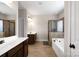 Elegant bathroom with double vanity, soaking tub, and walk-in shower at 5601 Ballenger Ct, Waxhaw, NC 28173