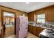 Kitchen with wood cabinets, pink refrigerator, and a stove at 2017 And 2025 Filbert Hwy, York, SC 29745