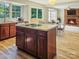 Kitchen with an island, wooden cabinets, and a view to the Gathering room at 9800 White Cascade Dr, Charlotte, NC 28269