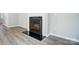 Modern fireplace with a black granite hearth and white mantel at 14303 Evening Flight Ln, Charlotte, NC 28262