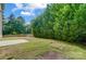 Private backyard with lush greenery and patio at 14303 Evening Flight Ln, Charlotte, NC 28262