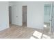 Bright bedroom featuring wood-look floors, a private bath, and a walk-in closet at 830 Oakshire Cir, Charlotte, NC 28214