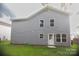Gray vinyl-sided house with multiple windows and a white door at 830 Oakshire Cir, Charlotte, NC 28214