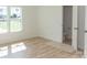 Bright bedroom with light wood-look flooring and private bathroom at 830 Oakshire Cir, Charlotte, NC 28214