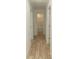 Light hallway with light wood-look flooring and doors to other rooms at 830 Oakshire Cir, Charlotte, NC 28214