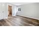 Bedroom with vinyl plank flooring and access to bathroom at 50444 Haven Bend Rd, Albemarle, NC 28001