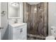 Bathroom with shower, white vanity, and marble countertop at 50444 Haven Bend Rd, Albemarle, NC 28001