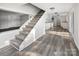 Modern stairs leading to upper level, with kitchen and dining area visible at 50444 Haven Bend Rd, Albemarle, NC 28001