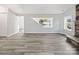 Bright living room features lake view window, fireplace, and vinyl plank flooring at 50444 Haven Bend Rd, Albemarle, NC 28001