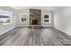Finished basement featuring a stone fireplace and gray vinyl plank flooring at 50444 Haven Bend Rd, Albemarle, NC 28001