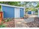 Blue shed with white door and landscaping at 50444 Haven Bend Rd, Albemarle, NC 28001