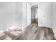 Light-filled hallway with wood-look floors and access to other rooms at 50444 Haven Bend Rd, Albemarle, NC 28001