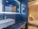 Modern bathroom with a floating vanity, marble countertops, and a sleek illuminated mirror at 323 Atherton St, Charlotte, NC 28203