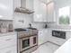Modern kitchen with stainless steel appliances and white cabinets at 323 Atherton St, Charlotte, NC 28203