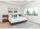 Spacious main bedroom with a floating bed, wood nightstands, and large windows at 323 Atherton St, Charlotte, NC 28203