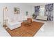 Living room with white sectional sofa, tiger print rug, and marble floors at 323 Atherton St, Charlotte, NC 28203