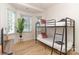Bright bedroom with a bunk bed, large windows, and hardwood floors at 323 Atherton St, Charlotte, NC 28203