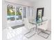 Modern dining area with glass table and white chairs, access to deck at 323 Atherton St, Charlotte, NC 28203
