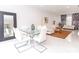 Bright dining area with glass table and white chairs, adjacent to living room and kitchen at 323 Atherton St, Charlotte, NC 28203