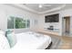 Main bedroom with large windows and a mounted TV at 323 Atherton St, Charlotte, NC 28203