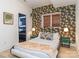 Cozy bedroom with patterned wallpaper, a comfortable bed, and bedside tables at 323 Atherton St, Charlotte, NC 28203