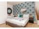 King-size bedroom with patterned wall, comfortable bedding, and hardwood floors at 323 Atherton St, Charlotte, NC 28203