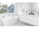 Spa-like bathroom with a soaking tub, double vanity, and marble shower at 323 Atherton St, Charlotte, NC 28203