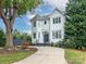 Two-story house with white siding, a dark gray door, and a landscaped yard at 323 Atherton St, Charlotte, NC 28203