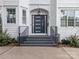 Modern house entrance with dark gray door and black metal railings at 323 Atherton St, Charlotte, NC 28203