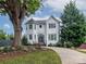 Two-story house with white siding, a dark gray door, and a landscaped yard at 323 Atherton St, Charlotte, NC 28203